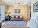 Cozy living room featuring a decorative chandelier, neutral paint, and comfortable furniture at 1421 Arbitus Cir, Oviedo, FL 32765