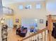 Spacious living room featuring high ceilings, hardwood floors, and a comfortable seating area at 1421 Arbitus Cir, Oviedo, FL 32765