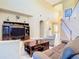 Spacious living room with tall ceilings, beautiful staircase and comfortable furnishings at 1421 Arbitus Cir, Oviedo, FL 32765