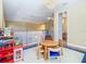 Upstairs loft area with chandelier lighting, play area and a view of the bathroom at 1421 Arbitus Cir, Oviedo, FL 32765