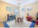 Bright playroom with a chandelier, round table, and lots of storage at 1421 Arbitus Cir, Oviedo, FL 32765