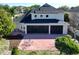 Aerial view showcasing the rear exterior featuring a screened lanai and patio with mature trees and landscaping at 1421 Arbitus Cir, Oviedo, FL 32765