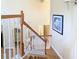 Well-lit staircase with wood railing and white balusters leading to the upper level at 1421 Arbitus Cir, Oviedo, FL 32765