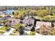 Residential neighborhood showing a charming home with a screened-in pool, lush landscaping, and a nearby lake at 14266 Squirrel Run, Orlando, FL 32828