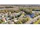 Beautiful aerial view of a residential area with trees, lakes, and many rooftops at 14266 Squirrel Run, Orlando, FL 32828