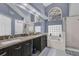 Bright bathroom with double vanity, granite counters, glass block window, and a tub at 14266 Squirrel Run, Orlando, FL 32828