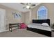 Cozy bedroom featuring a window, ceiling fan, a bed with drawers, and a desk at 14266 Squirrel Run, Orlando, FL 32828