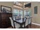 Bright dining room features a dark wood table and chairs, and a large window at 14266 Squirrel Run, Orlando, FL 32828