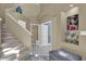 A home's entryway featuring stairs to the upper level, a bathroom, and art at 14266 Squirrel Run, Orlando, FL 32828