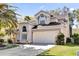 Charming two-story home with a well-manicured lawn, two-car garage, and appealing architectural details at 14266 Squirrel Run, Orlando, FL 32828