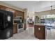 Open kitchen with island, granite counters, view to dining and screened patio, stainless appliances at 14266 Squirrel Run, Orlando, FL 32828