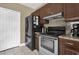 Galley kitchen with granite counters, stainless appliances, and warm wood cabinetry at 14266 Squirrel Run, Orlando, FL 32828