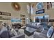 Comfortable living room with gray seating, a large TV, and view to pool area at 14266 Squirrel Run, Orlando, FL 32828