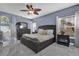 Elegant main bedroom with a ceiling fan, large windows, tile floors, and nice decor at 14266 Squirrel Run, Orlando, FL 32828
