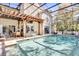 Inviting screened-in pool area with a covered pergola, ample seating, and access to the home at 14266 Squirrel Run, Orlando, FL 32828