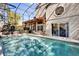 Screened-in pool area featuring a covered patio with stylish outdoor furniture, perfect for relaxation at 14266 Squirrel Run, Orlando, FL 32828