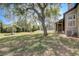 Spacious backyard with mature oak tree and view of the side of the house at 1570 Farrindon Cir, Lake Mary, FL 32746