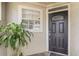 Inviting front entrance featuring a black door, sidelight, and decorative window at 1570 Farrindon Cir, Lake Mary, FL 32746