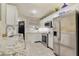 Kitchen featuring white cabinets, stainless steel appliances, and tiled flooring at 1570 Farrindon Cir, Lake Mary, FL 32746