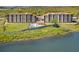 Scenic aerial view of lakeside condominiums with lush landscaping and a tranquil water view at 16300 County Road 455 # 401, Montverde, FL 34756