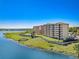 Breathtaking aerial perspective of lakeside condominium complex offering serene waterfront living and scenic beauty at 16300 County Road 455 # 401, Montverde, FL 34756