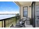Inviting balcony with comfortable seating overlooking a tranquil lake, perfect for relaxation at 16300 County Road 455 # 401, Montverde, FL 34756
