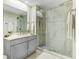 Elegant bathroom with glass enclosed shower and grey vanity with sink and storage at 16300 County Road 455 # 401, Montverde, FL 34756