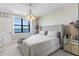 Bedroom with a large bed and lake view from the window at 16300 County Road 455 # 401, Montverde, FL 34756