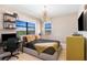 Bedroom featuring contemporary furnishings, including a chandelier, and a view through the large window at 16300 County Road 455 # 401, Montverde, FL 34756