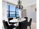 Dining room with modern chandelier and a breathtaking lake view from a large window at 16300 County Road 455 # 401, Montverde, FL 34756