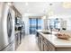 Modern kitchen with stainless appliances and a breakfast bar overlooking water views at 16300 County Road 455 # 401, Montverde, FL 34756