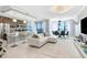 Bright living room and kitchen open concept with marble floors, chandeliers and serene water views at 16300 County Road 455 # 401, Montverde, FL 34756