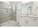 Bright bathroom featuring a glass shower, neutral tile, and white vanity with modern hardware at 16354 Silver Grove Blvd, Winter Garden, FL 34787