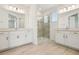 Bright bathroom with double vanities, marble countertops, and a glass-enclosed shower at 16354 Silver Grove Blvd, Winter Garden, FL 34787