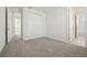Carpeted bedroom featuring white walls, closet doors, and multiple doorways at 16354 Silver Grove Blvd, Winter Garden, FL 34787