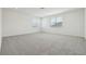 Spacious bedroom featuring plush carpeting, white walls, and natural light from two windows at 16354 Silver Grove Blvd, Winter Garden, FL 34787