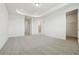 Large carpeted bedroom featuring tray ceilings, natural light, and multiple doors at 16354 Silver Grove Blvd, Winter Garden, FL 34787