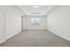 Large bedroom with neutral carpet, tray ceiling, and a window with natural light at 16354 Silver Grove Blvd, Winter Garden, FL 34787
