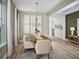 Elegant dining room with modern lighting, neutral colors, light wood floors, and lots of natural light at 16354 Silver Grove Blvd, Winter Garden, FL 34787