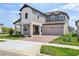Attractive two-story house showcasing a two-car garage and manicured front lawn at 16354 Silver Grove Blvd, Winter Garden, FL 34787