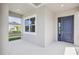 Inviting front porch with a view of the neighborhood and a blue front door at 16354 Silver Grove Blvd, Winter Garden, FL 34787