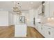 Open-concept kitchen with island, stainless steel appliances, and stylish pendant lighting at 16354 Silver Grove Blvd, Winter Garden, FL 34787