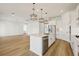 Open kitchen with a large island, stainless steel appliances, pendant lights, and wood flooring at 16354 Silver Grove Blvd, Winter Garden, FL 34787
