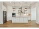 Modern kitchen with an island, stainless steel appliances, pendant lighting, and marble backsplash at 16354 Silver Grove Blvd, Winter Garden, FL 34787