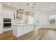 Bright kitchen features a large island, pendant lighting, stainless steel appliances, and marble backsplash at 16354 Silver Grove Blvd, Winter Garden, FL 34787