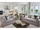 Open-concept living space with modern decor connecting to the kitchen, dining area, and pool views at 16354 Silver Grove Blvd, Winter Garden, FL 34787