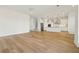 Open floor plan featuring wood floors, connecting the living area to the kitchen and staircase at 16354 Silver Grove Blvd, Winter Garden, FL 34787