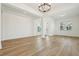 Bright and airy living room with hardwood floors, large windows, and a modern chandelier at 16354 Silver Grove Blvd, Winter Garden, FL 34787