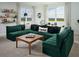 Vibrant, modern living room with emerald sectional, views, and decor at 16354 Silver Grove Blvd, Winter Garden, FL 34787