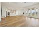 Large living room with wood floors seamlessly connects the kitchen and dining areas at 16354 Silver Grove Blvd, Winter Garden, FL 34787